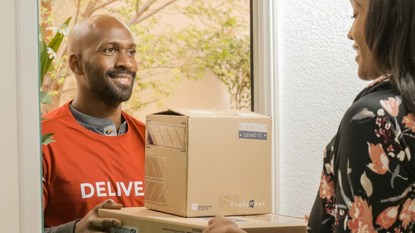 A courier handing over a delivery parcel